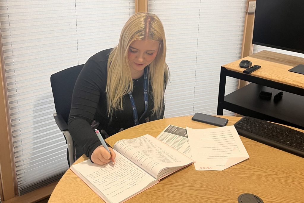 A young woman preparing for an interview by taking notes | Yacht Interview Tips